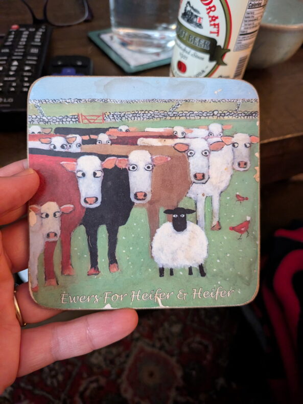 A coaster with cartoon sheep and the words "Ewers for Heifer & Heifer"